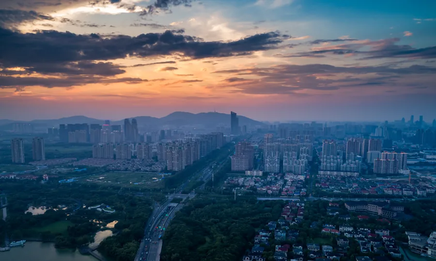 Aerial view of an expanding city district at dusk