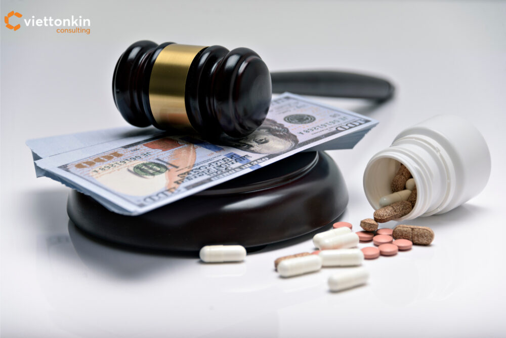 Pharmaceutical drug business concept with judge gavel on dollar bills and spilled medicine pills from a bottle, symbolizing regulation, law, and financial aspects of the pharmaceutical industry